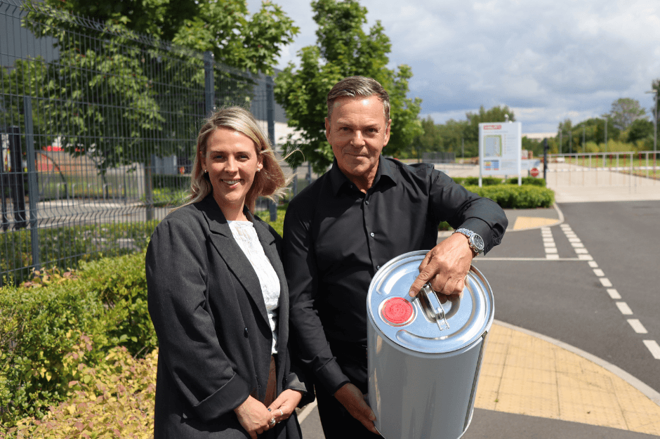 Mark Terniwski and Elise Wilkes from Invopak with a tinplate drum outside a UK factory