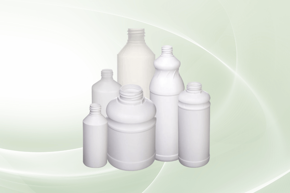 Set of white plastic bottles on a light green background