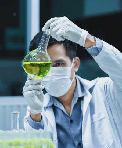 A scientist uses a glass flask in the laboratory